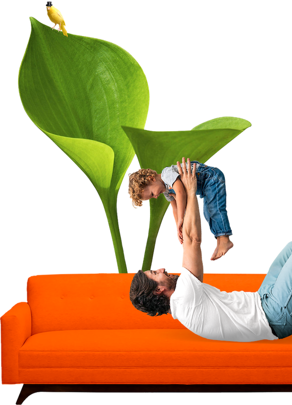 a man lifts a baby over his head while lying on a couch